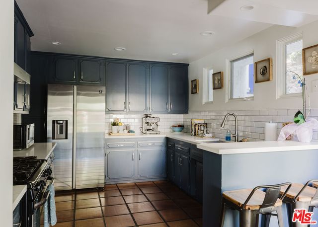 a kitchen with a sink stainless steel appliances and cabinets