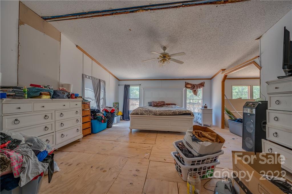 546 West V Thompson Road Rutherfordton, NC 28139 - Photo 6 of 17 a bedroom with a bed and a chandelier