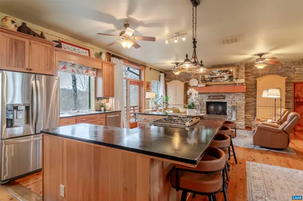 a bathroom with a granite countertop sink and a toilet