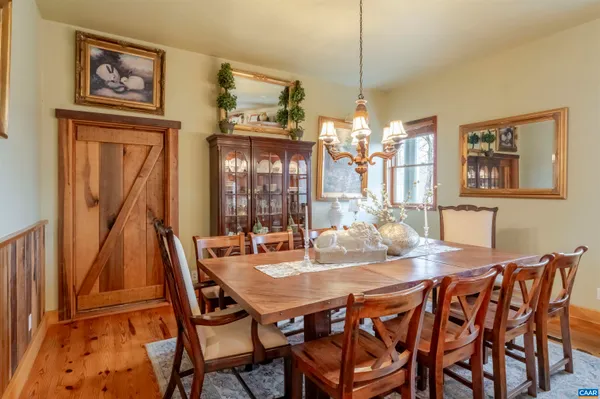 a bedroom with a bed a couch and a potted plant