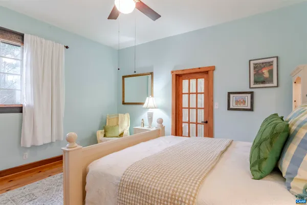 a bed room with a bed and a mirror