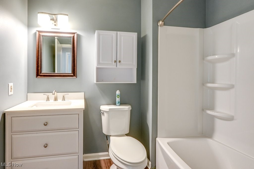 17414 Sheldon Road Brook Park, OH 44142 - Photo 16 of 25 Updated Full bathroom with wood-type flooring, vanity, bathing tub / shower combination, and toilet on second floor