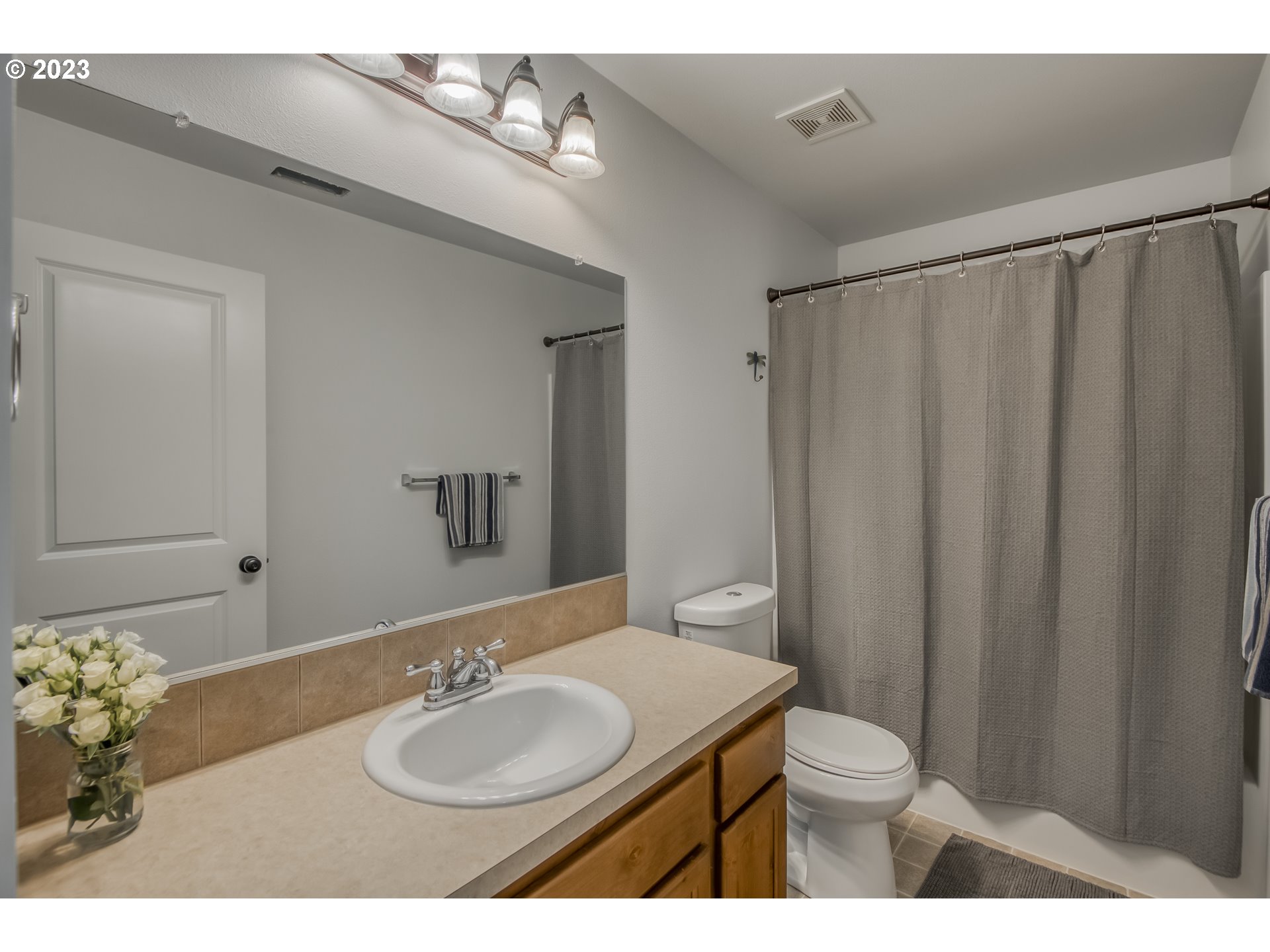 18074 Southwest Lotus Lane Beaverton, OR 97003 - Photo 12 of 19 a bathroom with a sink a toilet and a mirror