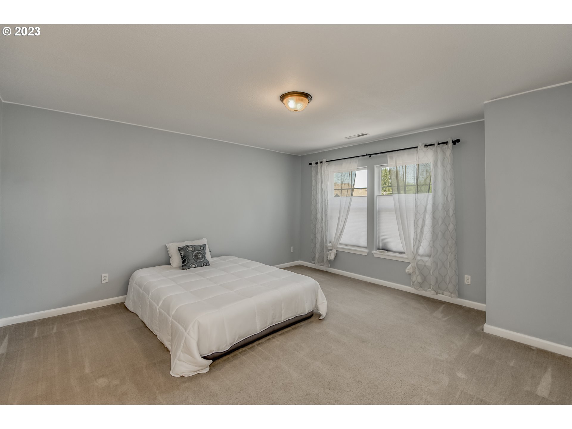 18074 Southwest Lotus Lane Beaverton, OR 97003 - Photo 13 of 19 a bedroom with a bed and a window