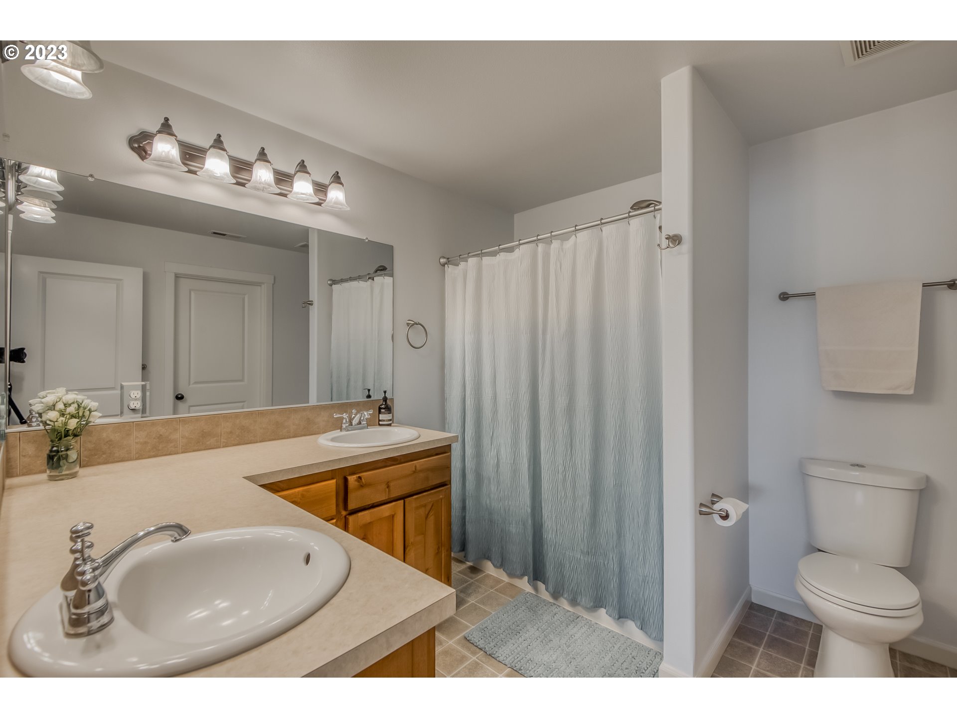 18074 Southwest Lotus Lane Beaverton, OR 97003 - Photo 14 of 19 a bathroom with a sink double vanity granite tub and a mirror