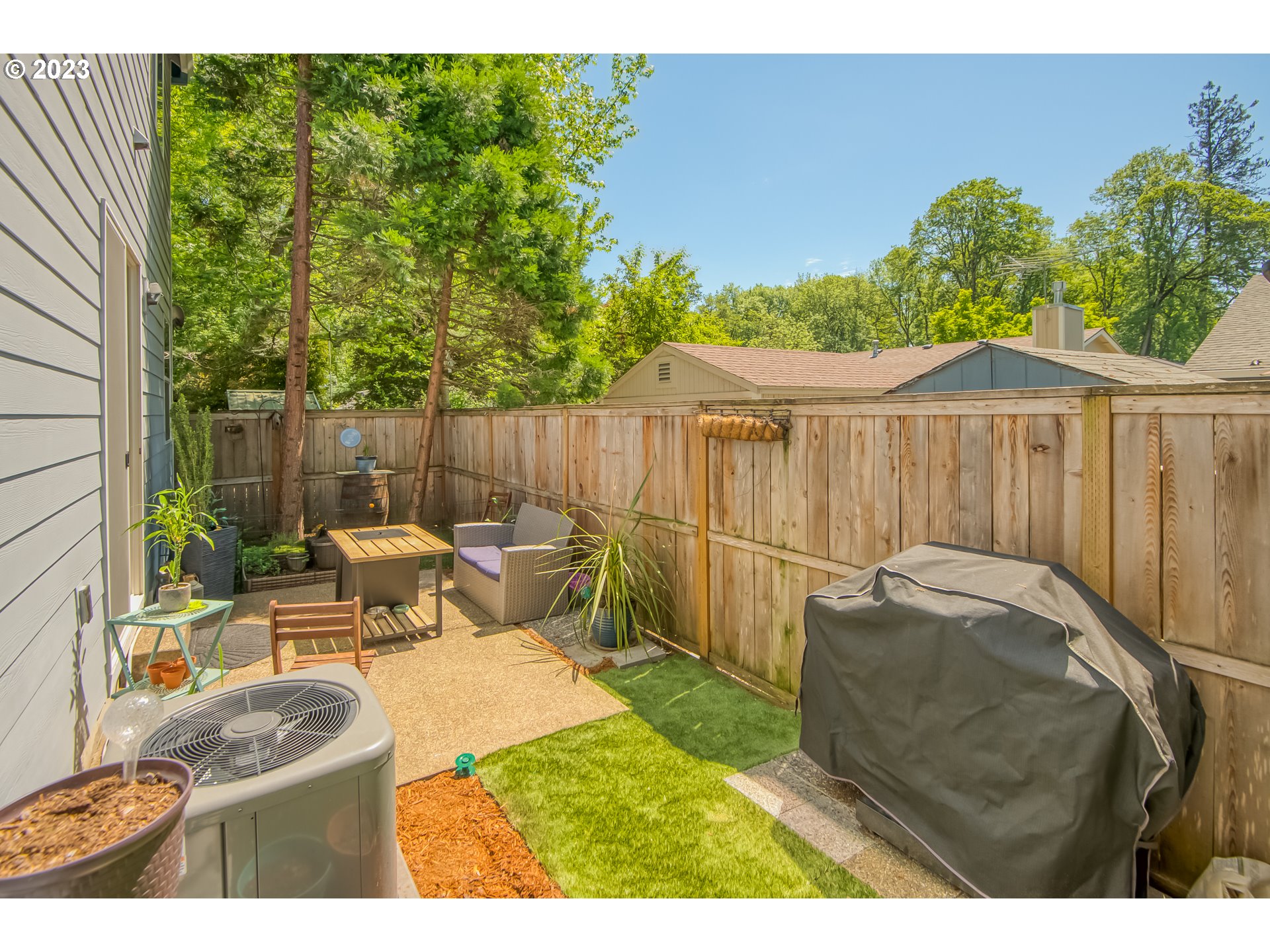 18074 Southwest Lotus Lane Beaverton, OR 97003 - Photo 16 of 19 a backyard of a house with table and chairs