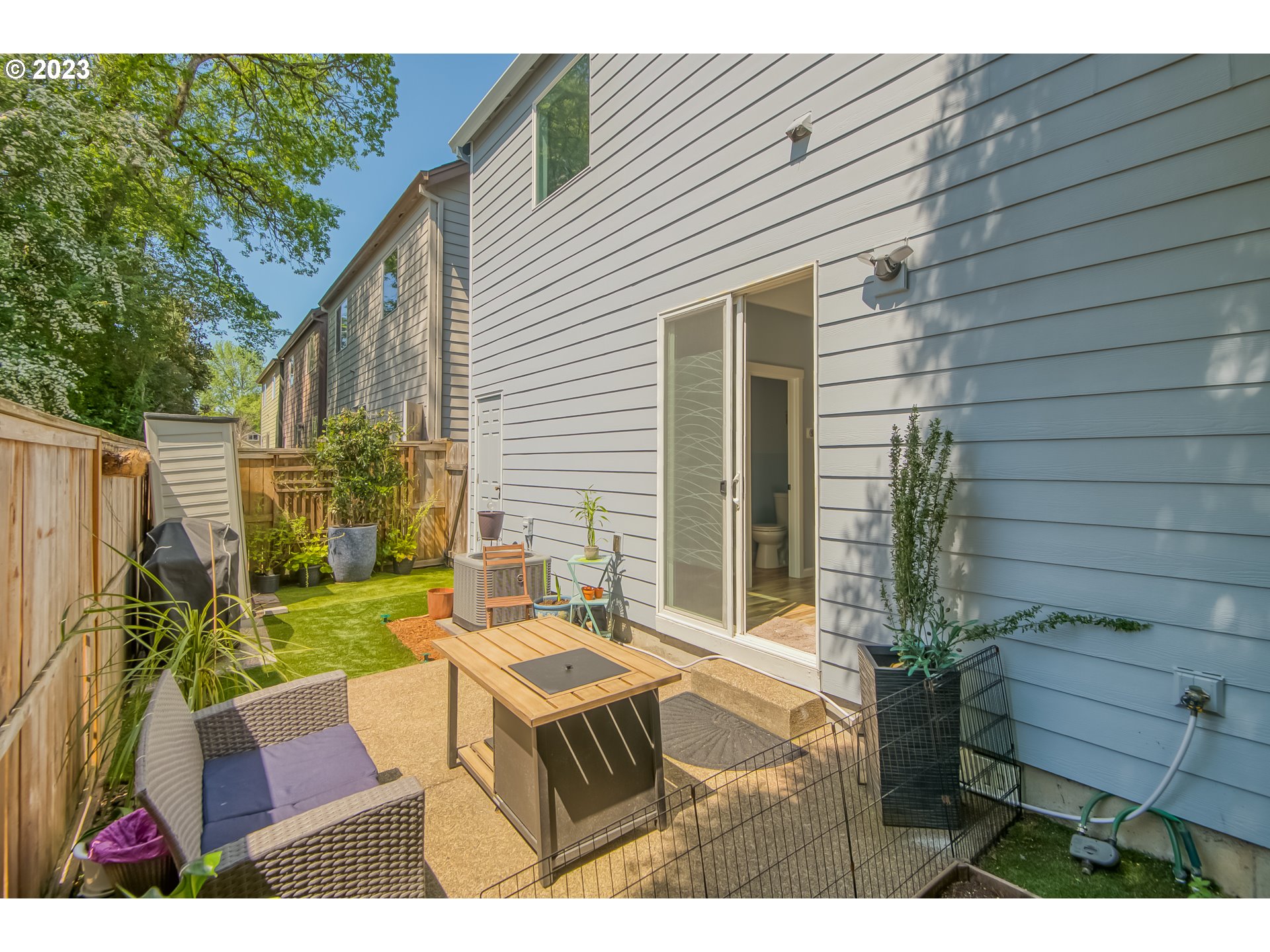 18074 Southwest Lotus Lane Beaverton, OR 97003 - Photo 18 of 19 a backyard of a house with table and chairs