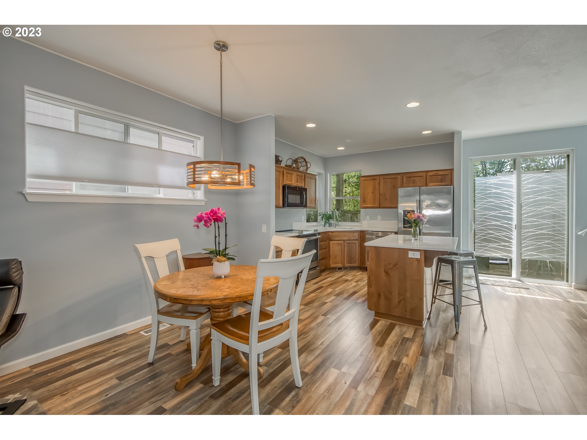 18074 Southwest Lotus Lane Beaverton, OR 97003 - Photo 5 of 19 a dinning room dining table chairs wooden floor and a view of kitchen