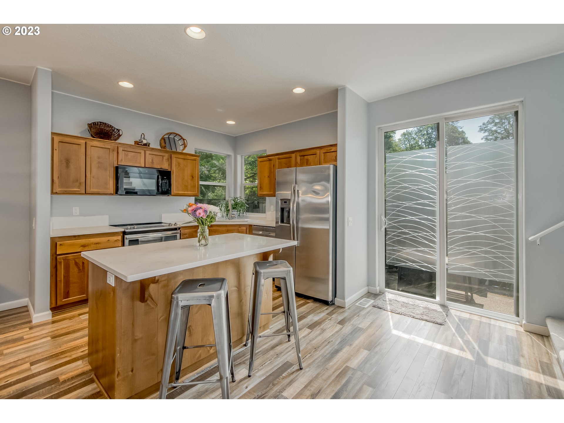 18074 Southwest Lotus Lane Beaverton, OR 97003 - Photo 7 of 19 a kitchen with stainless steel appliances granite countertop a stove a sink dishwasher and a refrigerator with wooden floor