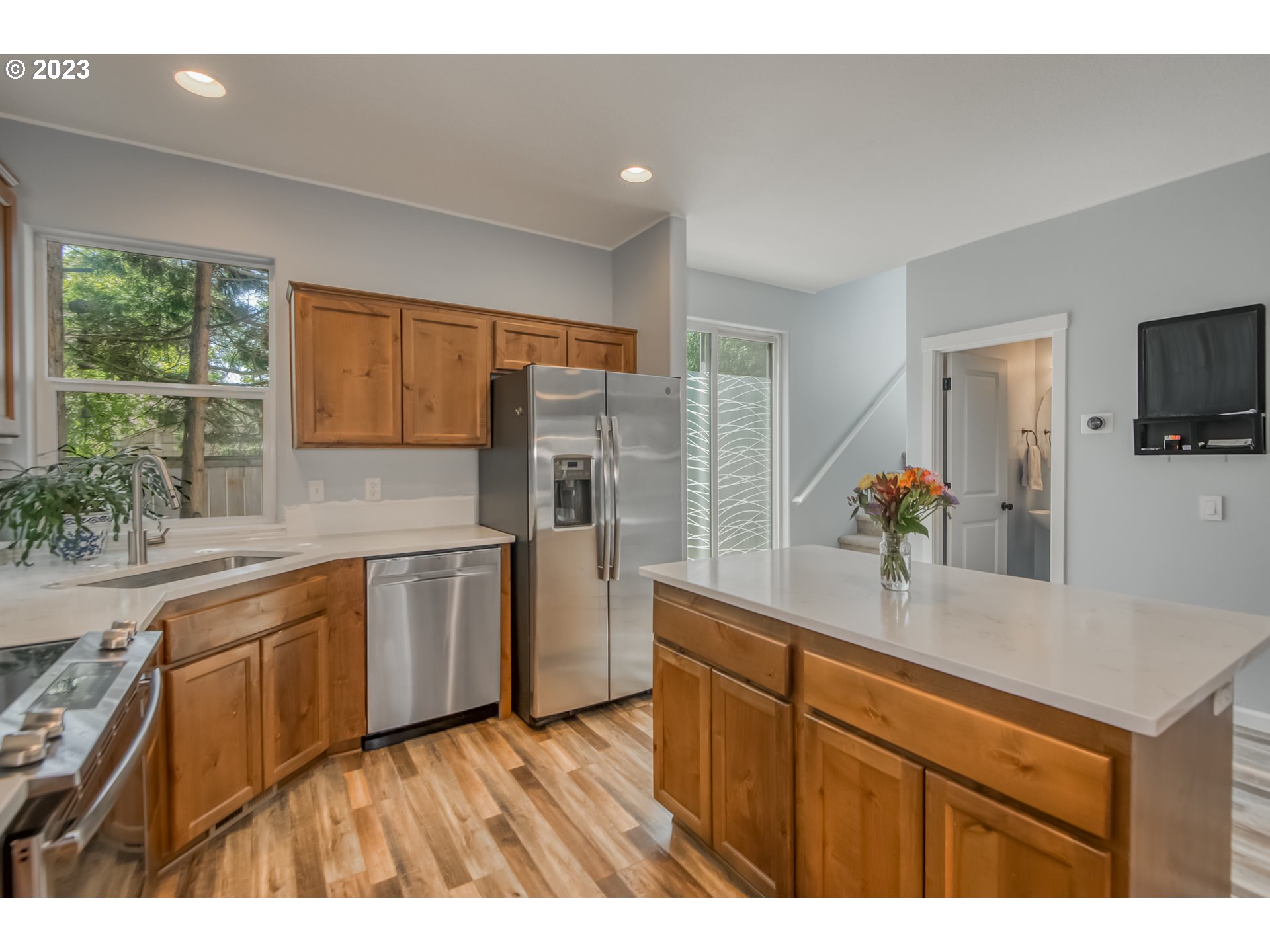 18074 Southwest Lotus Lane Beaverton, OR 97003 - Photo 8 of 19 a kitchen with stainless steel appliances granite countertop a sink and wooden cabinets