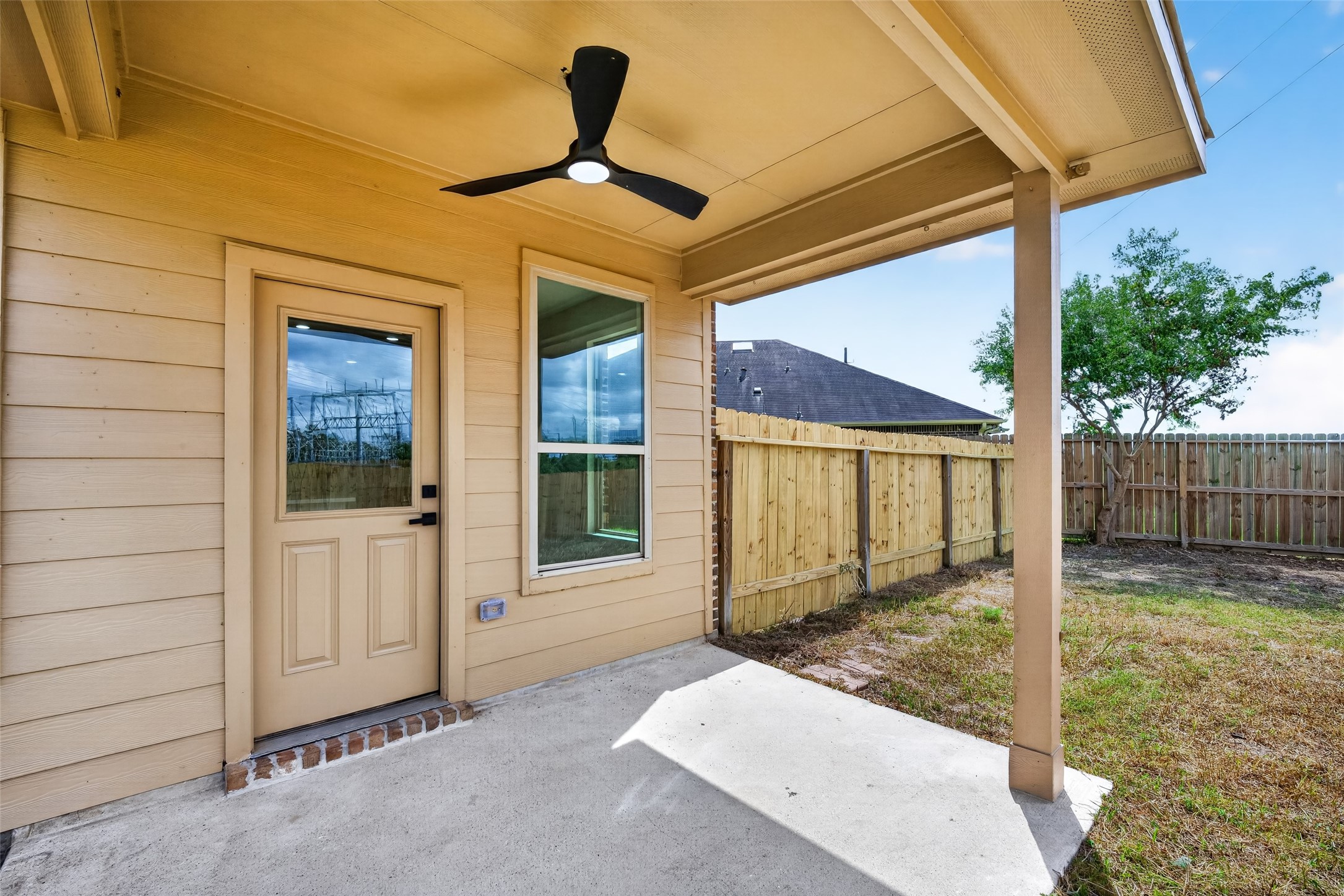22623 Ebbets Field Drive Spring, TX 77389 - Photo 40 of 43 Charming covered patio with a ceiling fan and fenced backyard, perfect for relaxation and outdoor gatherings.