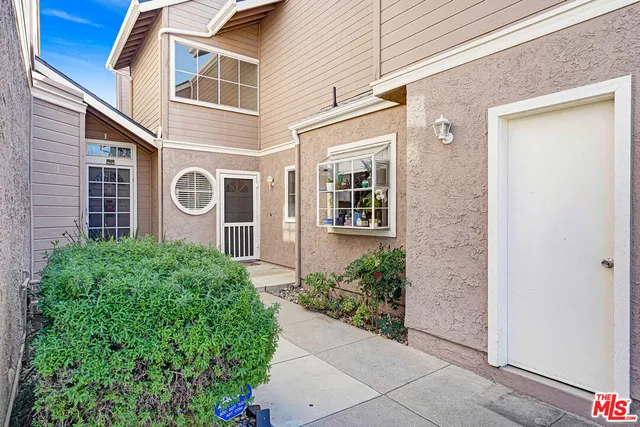 a view of a house with potted plants