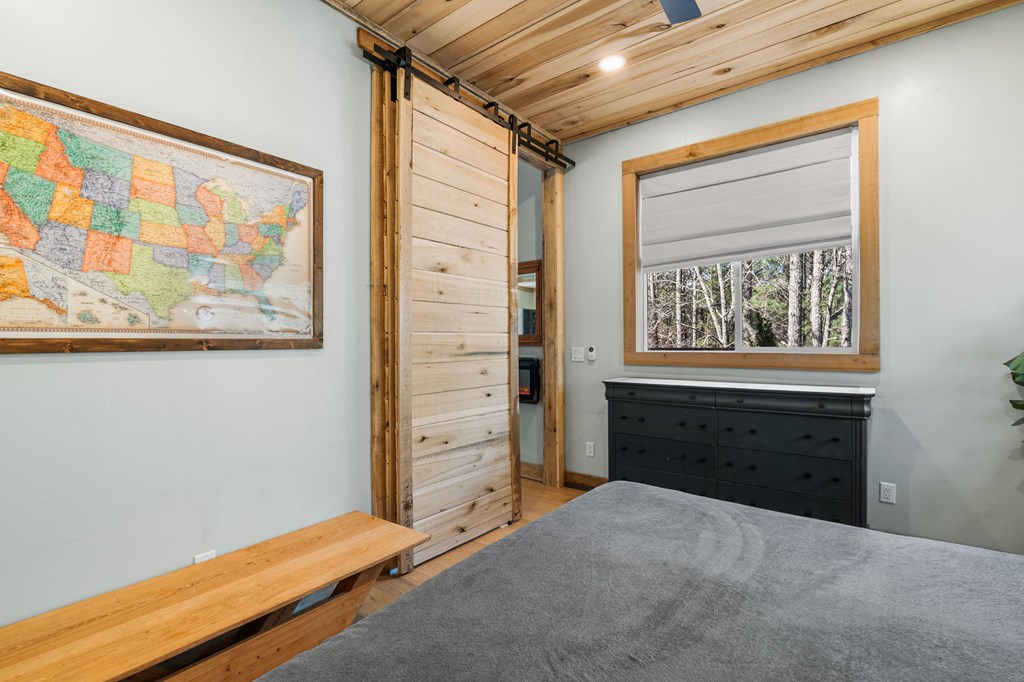126 Hummingbird Way Copperhill, TN 37317 - Photo 34 of 47 a bedroom with a bed and a dresser