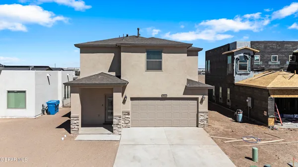 a view of a house with a barbeque