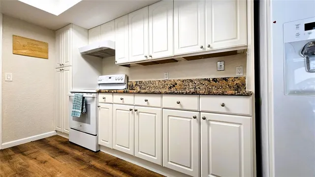 a bathroom with a granite countertop shower and a toilet