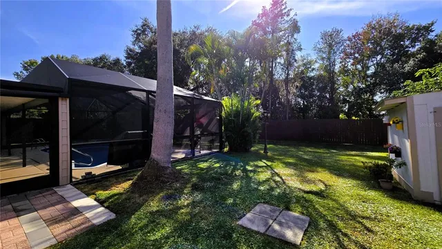 a backyard of a house with plants and outdoor seating