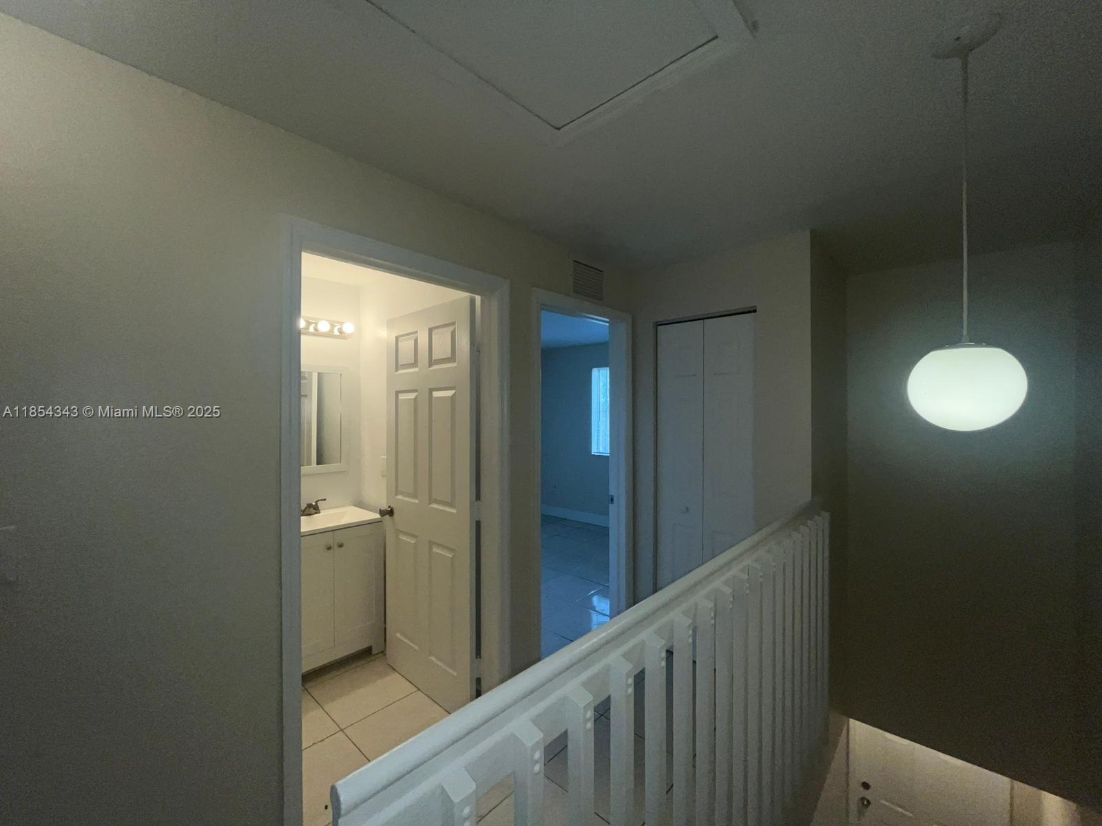 2251 Northwest 136th Terrace, Unit 2251 Opa-Locka, FL 33054 - Photo 11 of 20 a view of a bathroom from a hallway