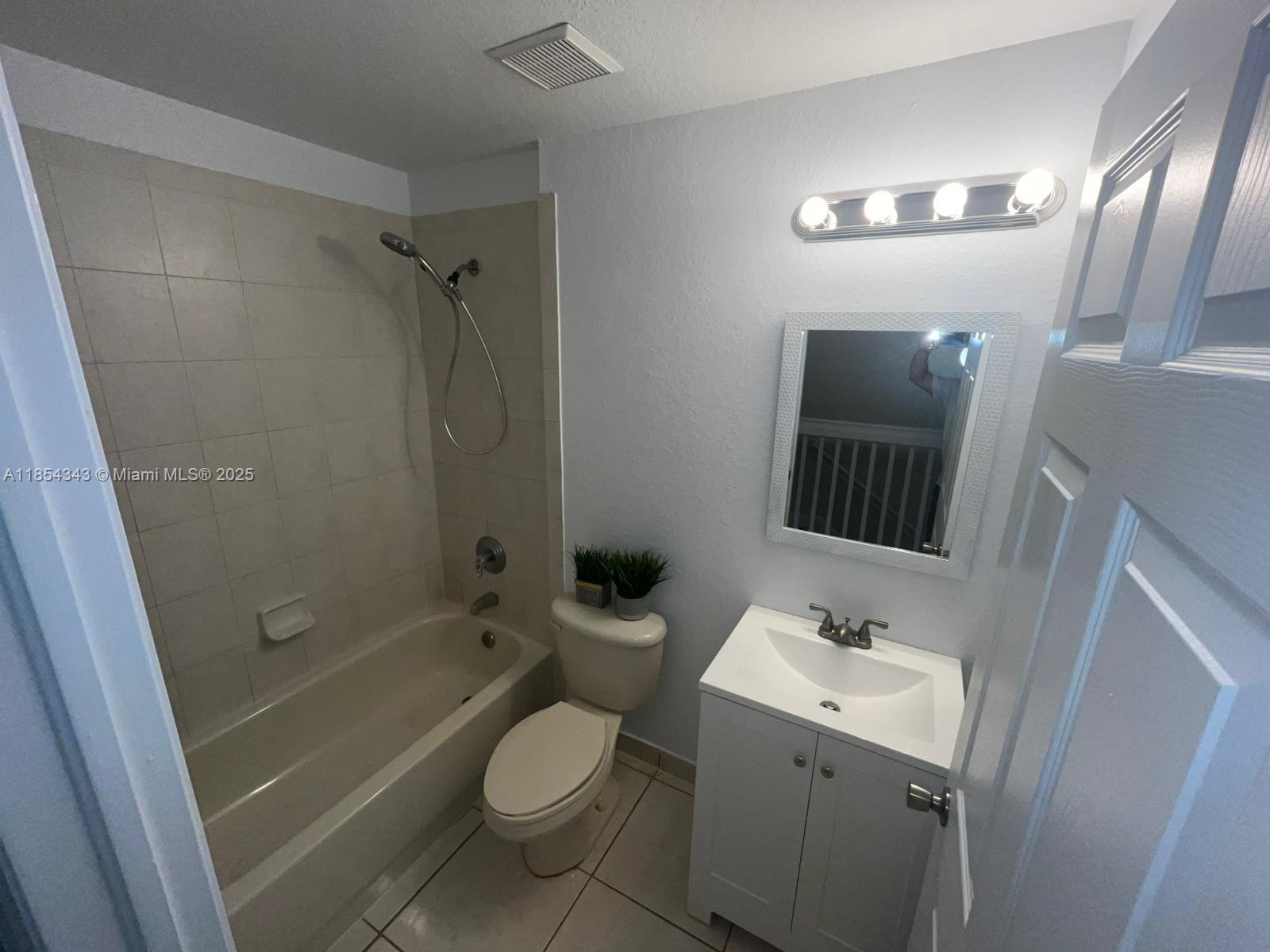 2251 Northwest 136th Terrace, Unit 2251 Opa-Locka, FL 33054 - Photo 12 of 20 a bathroom with a sink toilet and shower