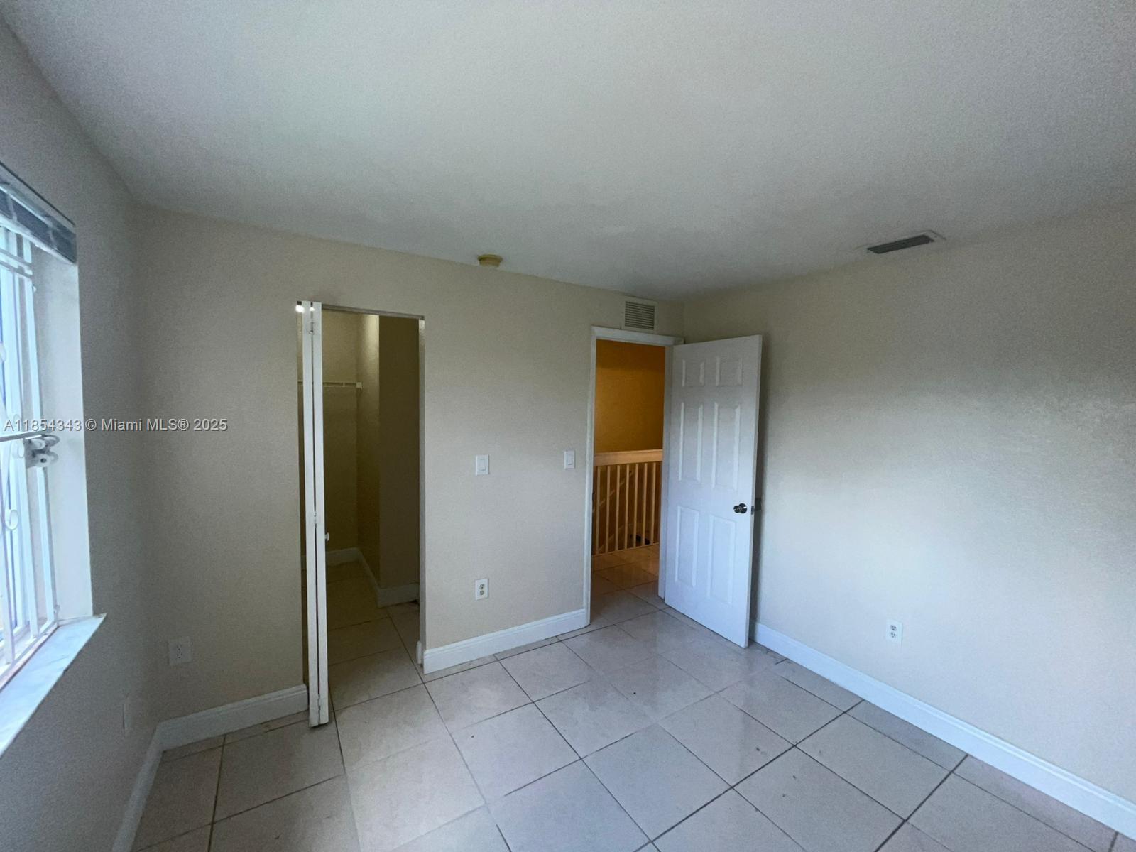 2251 Northwest 136th Terrace, Unit 2251 Opa-Locka, FL 33054 - Photo 14 of 20 an empty room with closet