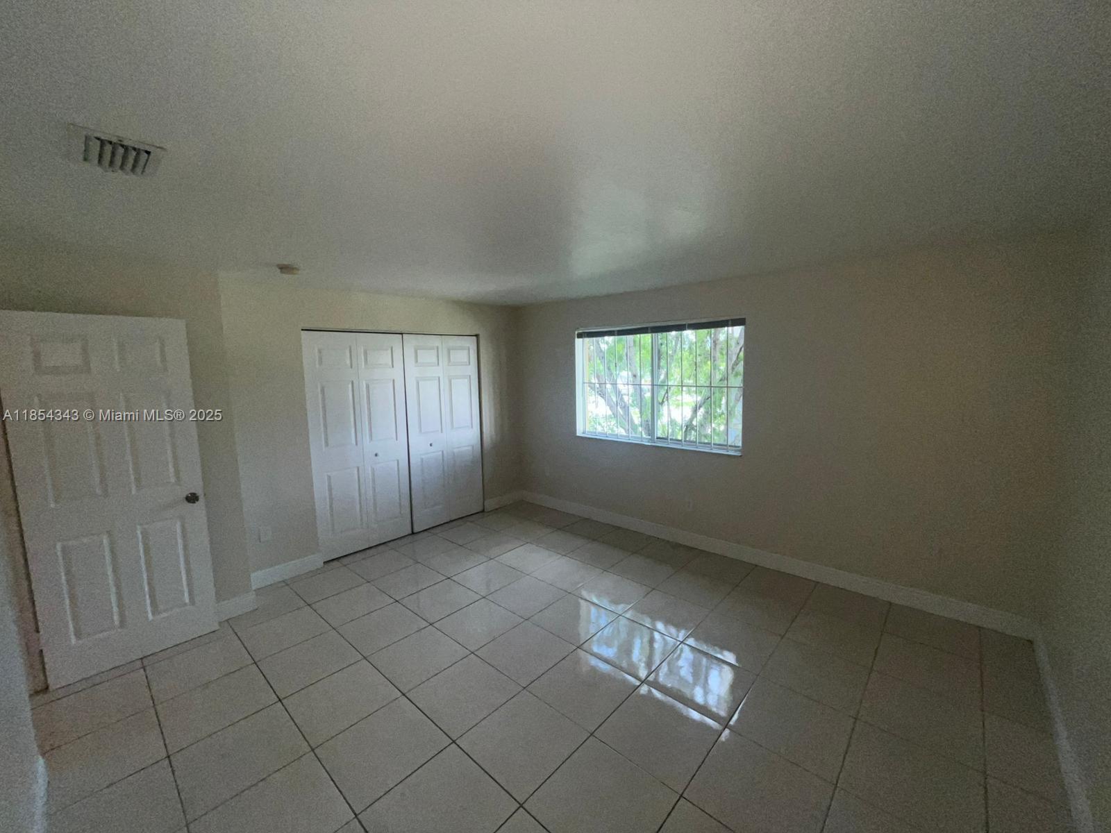 2251 Northwest 136th Terrace, Unit 2251 Opa-Locka, FL 33054 - Photo 16 of 20 an empty room with windows