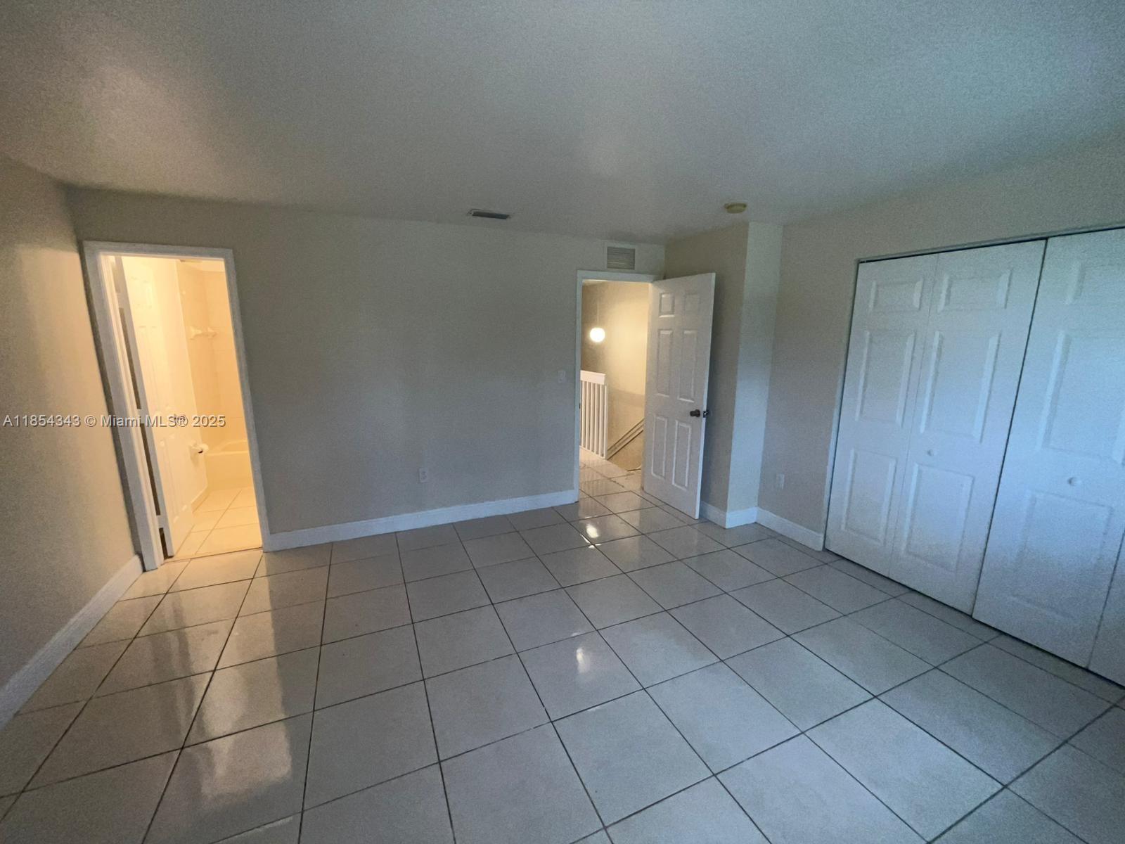 2251 Northwest 136th Terrace, Unit 2251 Opa-Locka, FL 33054 - Photo 17 of 20 a view of an empty room and window