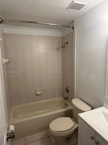 a bathroom with a toilet and a bath tub