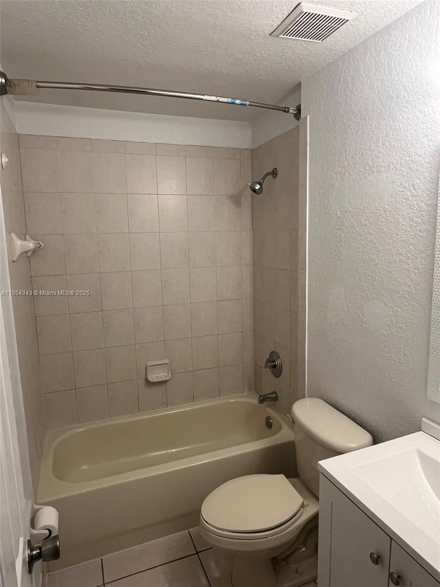 2251 Northwest 136th Terrace, Unit 2251 Opa-Locka, FL 33054 - Photo 18 of 20 a bathroom with a toilet and a bath tub