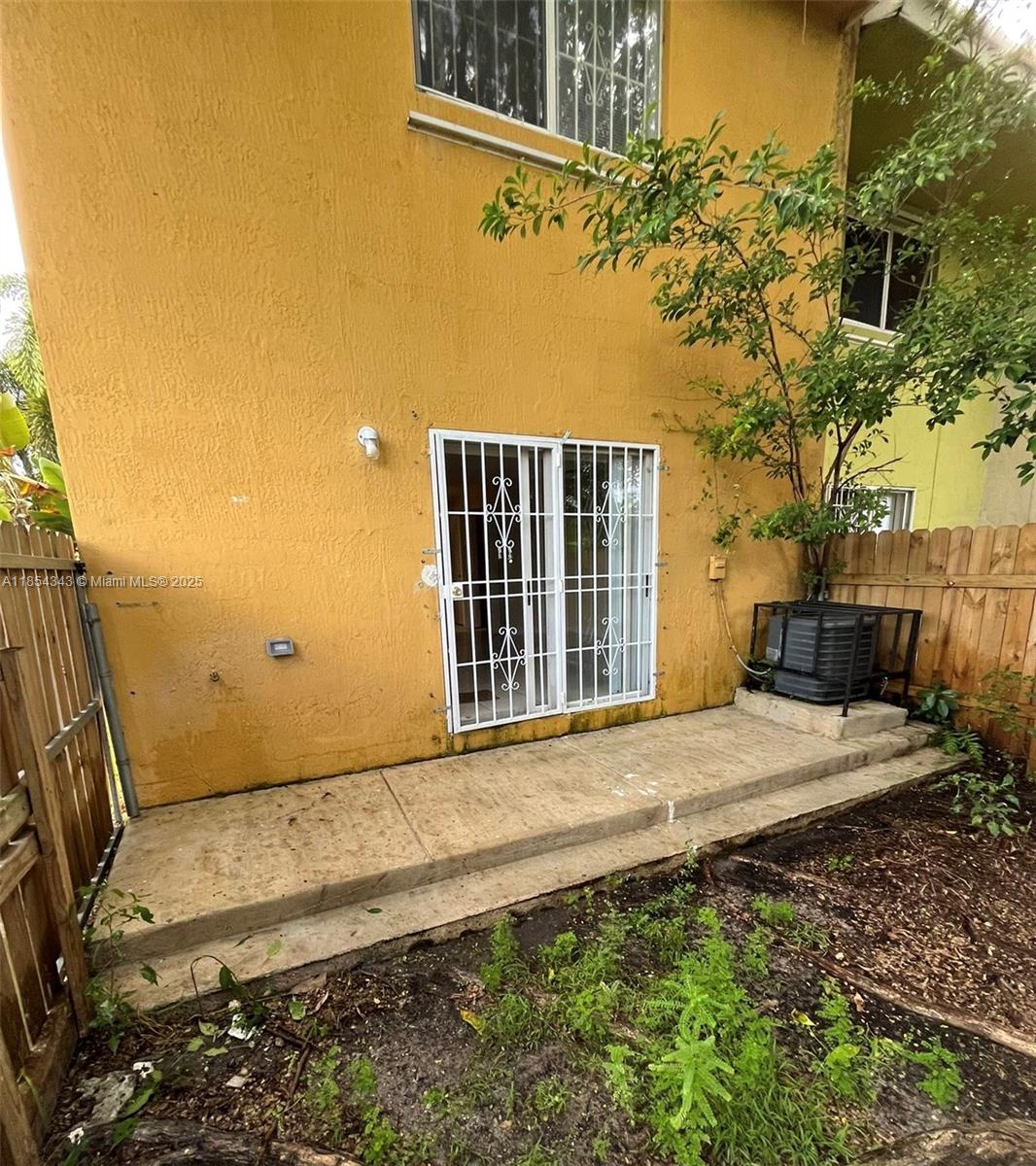2251 Northwest 136th Terrace, Unit 2251 Opa-Locka, FL 33054 - Photo 19 of 20 a front view of a house with a yard
