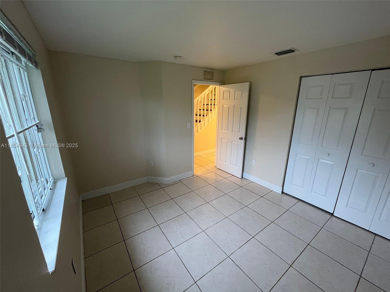 2251 Northwest 136th Terrace, Unit 2251 Opa-Locka, FL 33054 - Photo 4 of 20 a view of an entryway and a window in a room