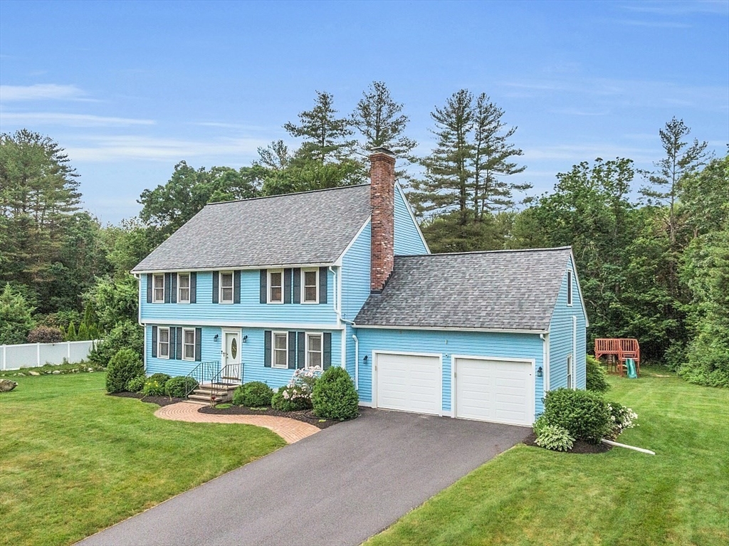 106 Reed Farm Road Boxborough, MA 01719 - Photo 1 of 40 a front view of a house with a yard and garage