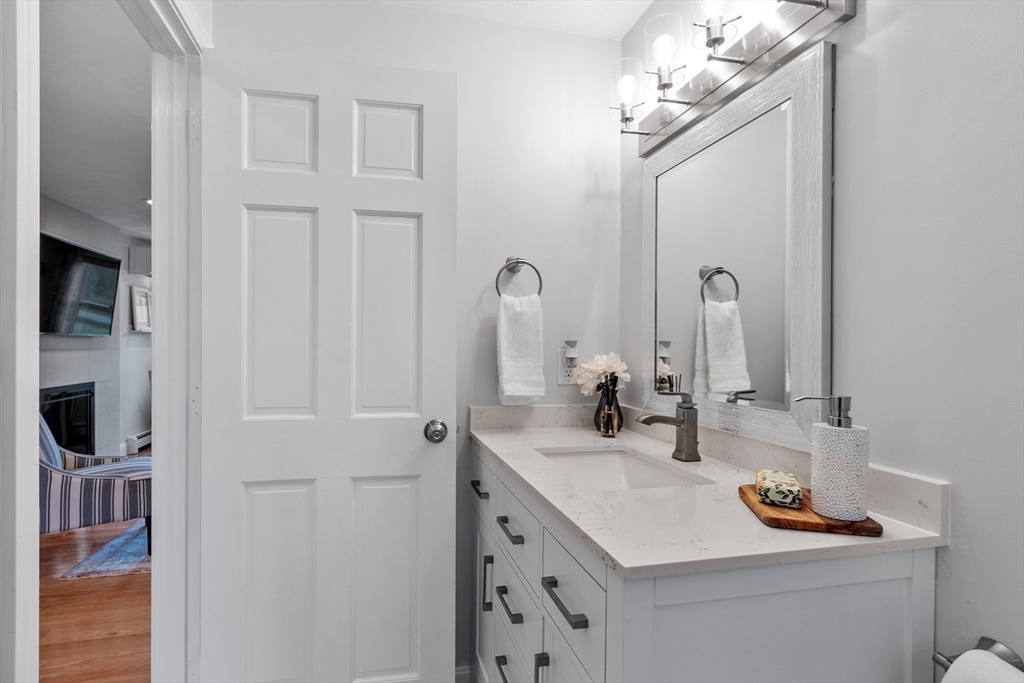 106 Reed Farm Road Boxborough, MA 01719 - Photo 14 of 40 a bathroom with a sink vanity and mirror