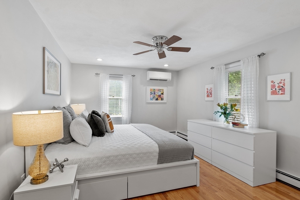 106 Reed Farm Road Boxborough, MA 01719 - Photo 24 of 40 a bedroom with a bed and a lamp on table with wooden floor