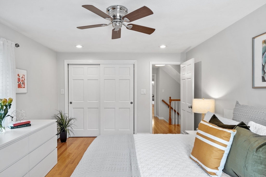 106 Reed Farm Road Boxborough, MA 01719 - Photo 25 of 40 a spacious bedroom with a bed and a chandelier