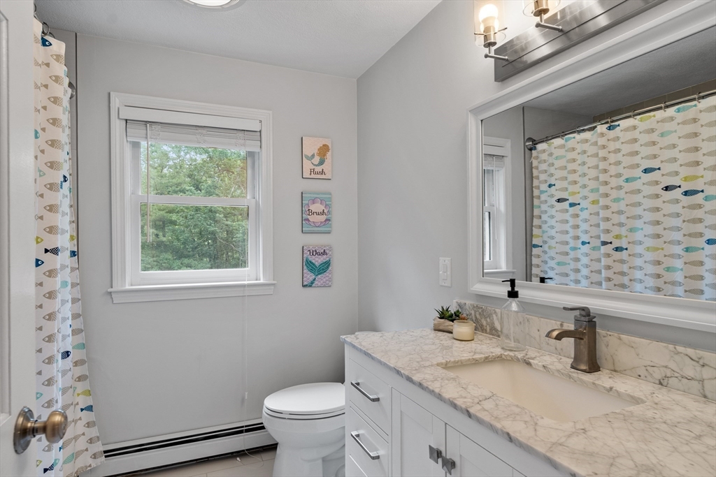 106 Reed Farm Road Boxborough, MA 01719 - Photo 30 of 40 a bathroom with a granite countertop sink toilet and mirror