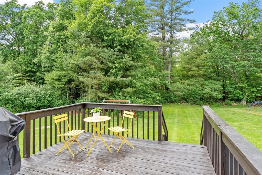 106 Reed Farm Road Boxborough, MA 01719 - Photo 33 of 40 a balcony with wooden floor and yard in the back