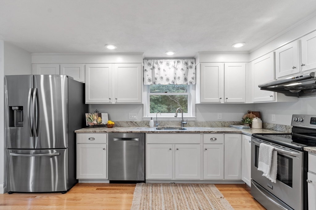 106 Reed Farm Road Boxborough, MA 01719 - Photo 6 of 40 a kitchen with stainless steel appliances granite countertop a stove a sink dishwasher a refrigerator and cabinets with wooden floor