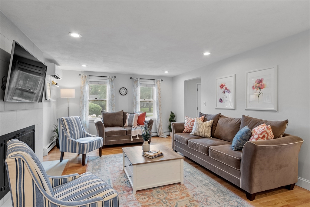 106 Reed Farm Road Boxborough, MA 01719 - Photo 8 of 40 a living room with furniture and a flat screen tv