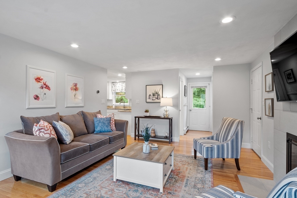 106 Reed Farm Road Boxborough, MA 01719 - Photo 9 of 40 a living room with furniture and a flat screen tv