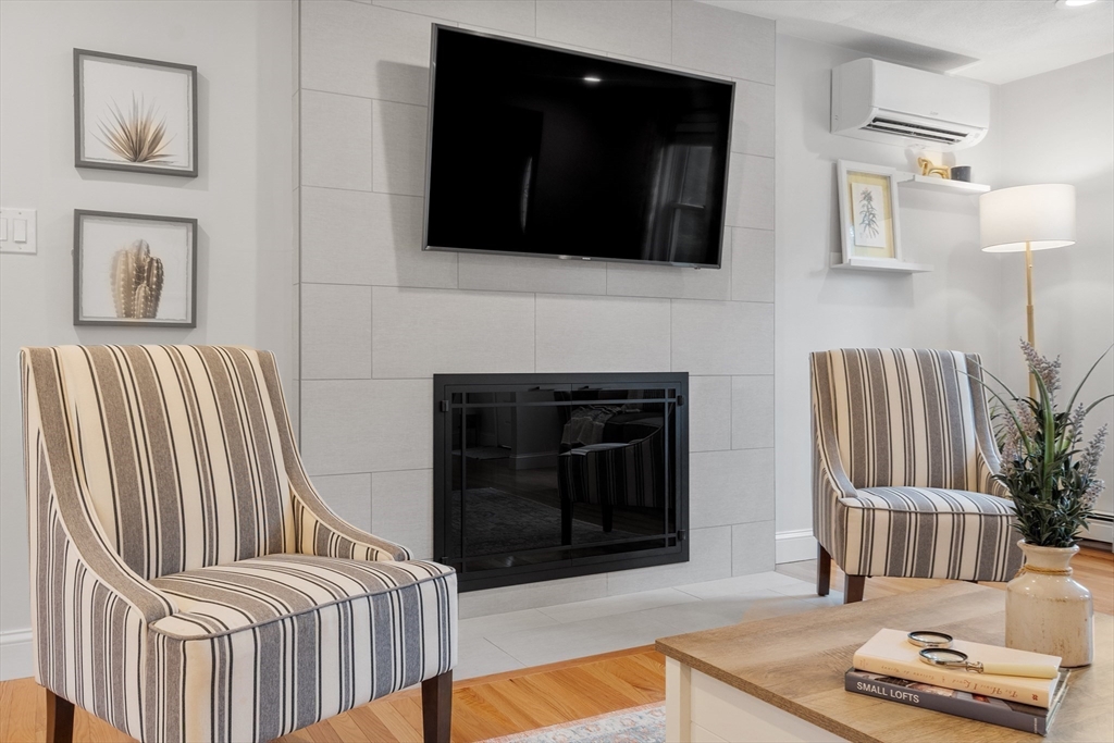 106 Reed Farm Road Boxborough, MA 01719 - Photo 10 of 40 a living room with furniture and a fireplace