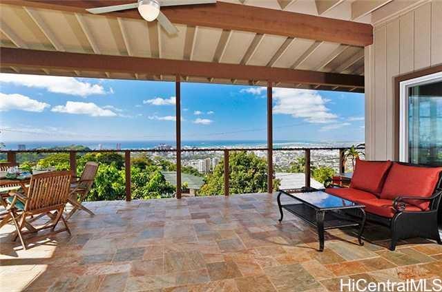 2951 Pacific Heights Road Honolulu, HI 96813 - Photo 1 of 1 a roof deck with a table and chairs under an umbrella