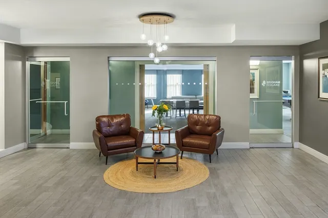 a living room with furniture and a chandelier