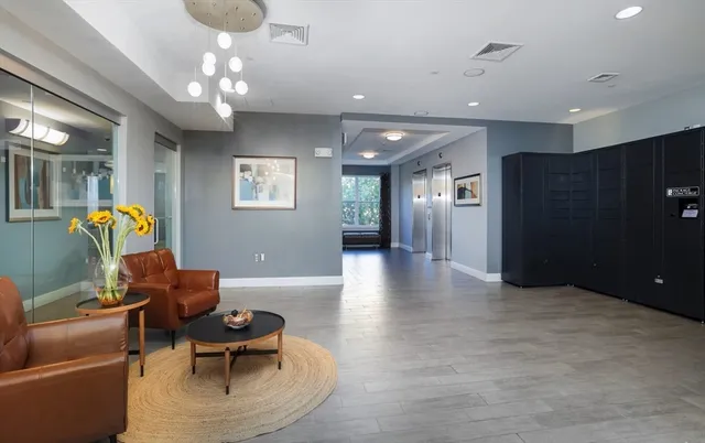 a living room with furniture and a chandelier