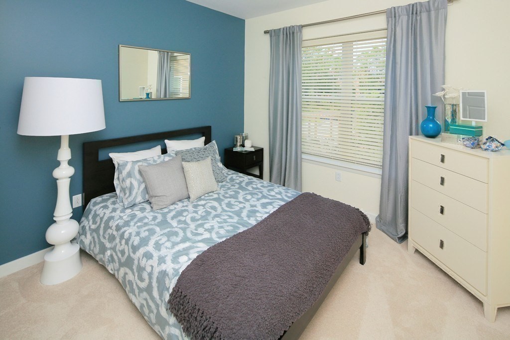 30 Mill Street, Unit 105 Arlington, MA 02476 - Photo 19 of 33 a bedroom with a bed and a lamp