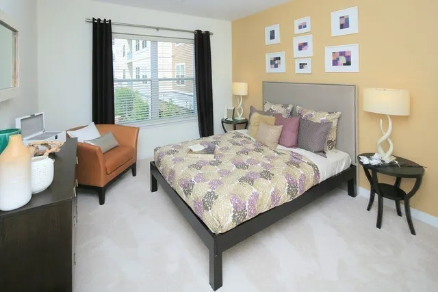 a bedroom with a bed and a window