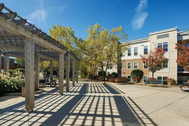 a balcony with wooden floor table and chairs