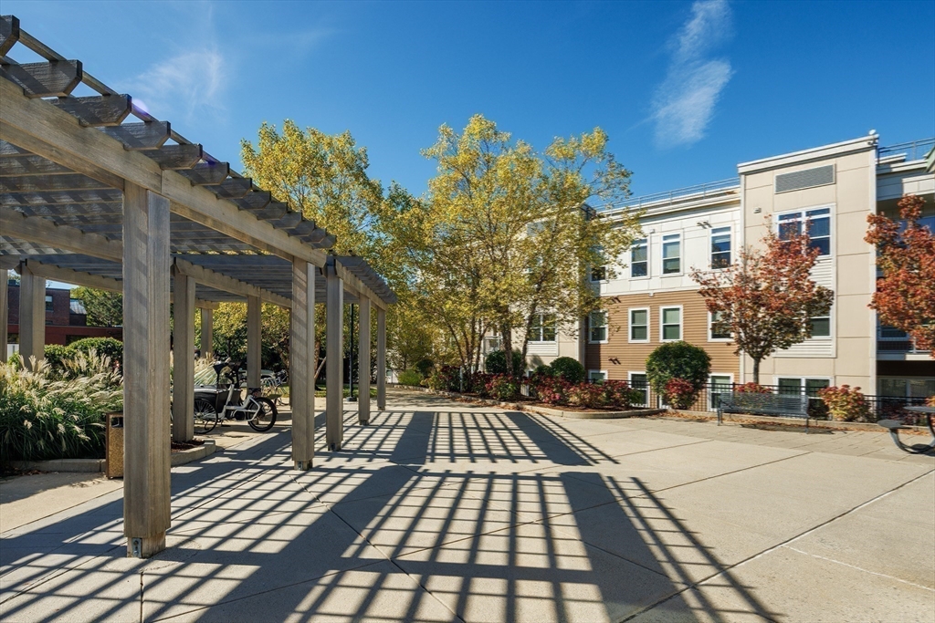 30 Mill Street, Unit 105 Arlington, MA 02476 - Photo 26 of 33 a view of a brick building with many windows