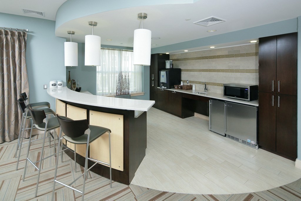 30 Mill Street, Unit 105 Arlington, MA 02476 - Photo 29 of 33 a kitchen with stainless steel appliances kitchen island a chandelier
