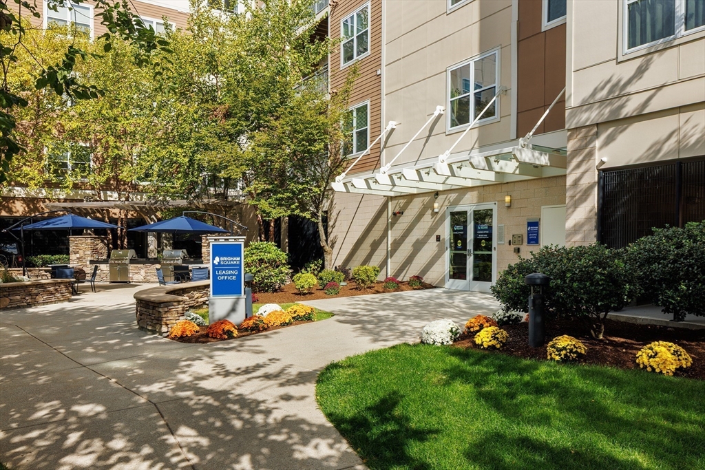30 Mill Street, Unit 105 Arlington, MA 02476 - Photo 3 of 33 a view of a chair and table in the back yard of the house