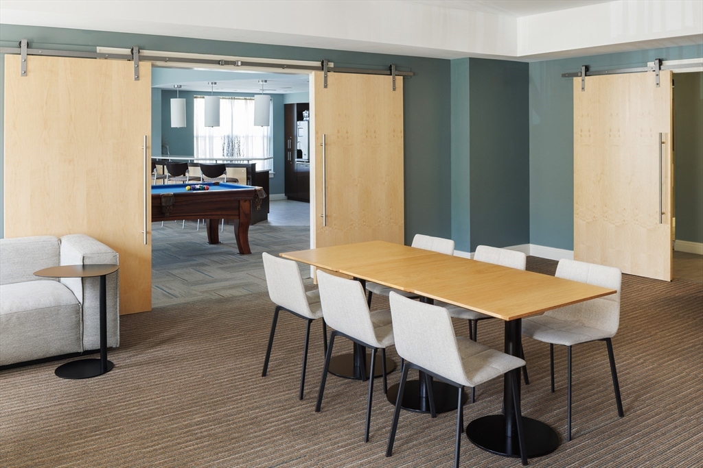 30 Mill Street, Unit 105 Arlington, MA 02476 - Photo 6 of 33 a view of a dining room with furniture and wooden floor