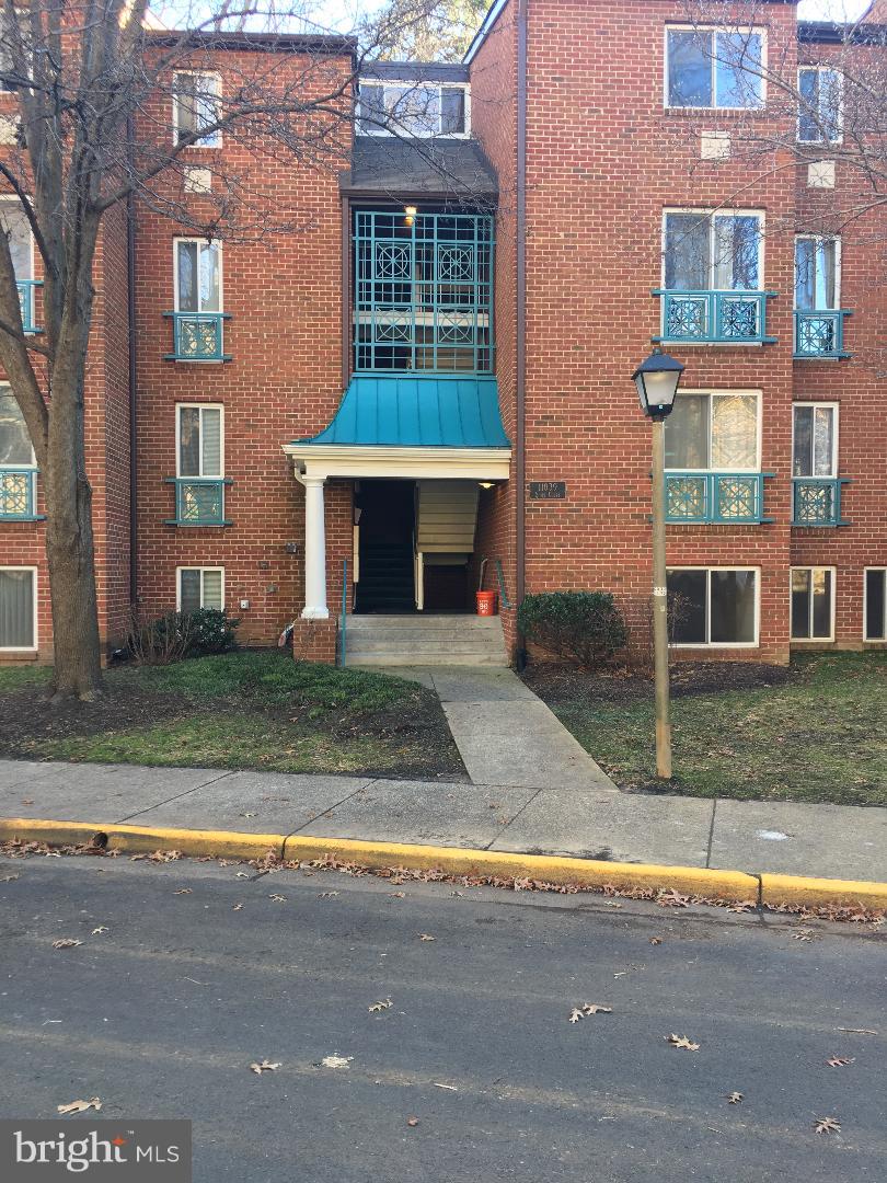 front view of a brick house next to a yard